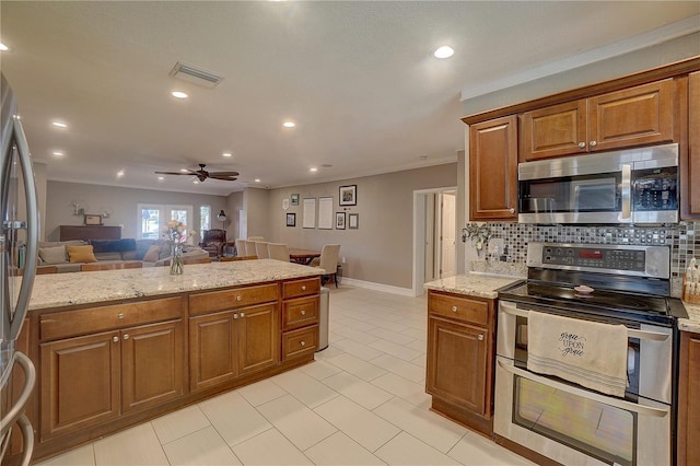 kitchen featuring stainless steel appliances, visible vents, decorative backsplash, brown cabinetry, and open floor plan
