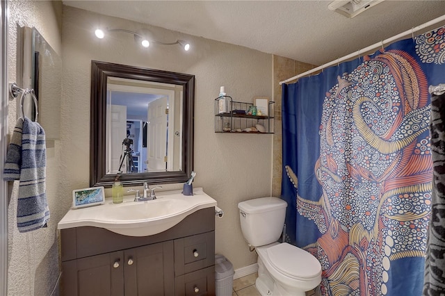 full bathroom featuring a textured wall, toilet, tile patterned floors, a textured ceiling, and vanity