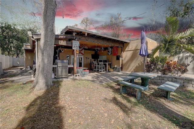 back of property with a patio and fence