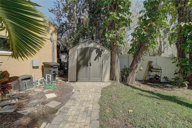 view of shed featuring fence