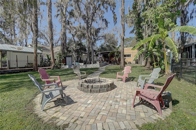 view of patio / terrace with an outdoor fire pit and fence