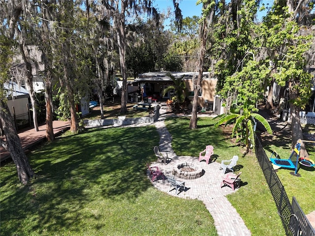 view of yard featuring a patio area, fence, and a fire pit