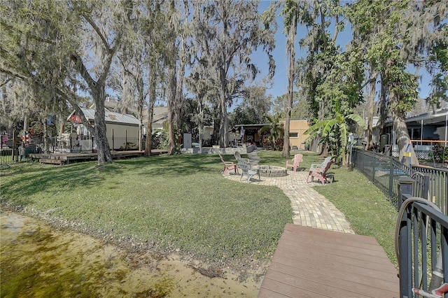 view of yard with an outdoor fire pit, fence, and a patio