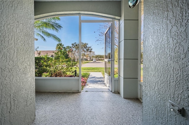 doorway featuring speckled floor