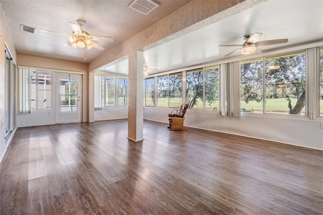 unfurnished sunroom with ceiling fan and visible vents