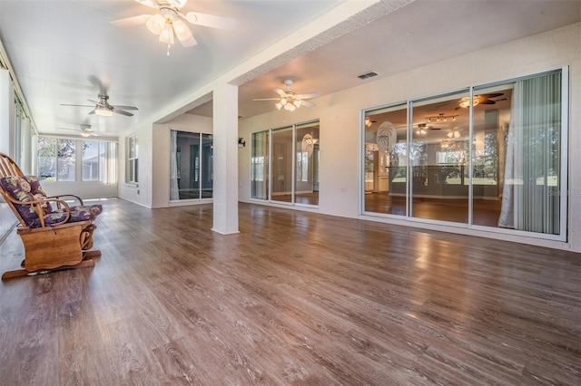 unfurnished sunroom with a ceiling fan and visible vents