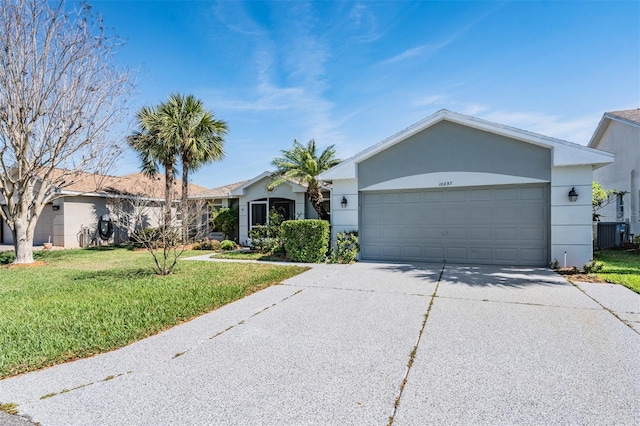 single story home featuring central air condition unit, a garage, concrete driveway, stucco siding, and a front lawn