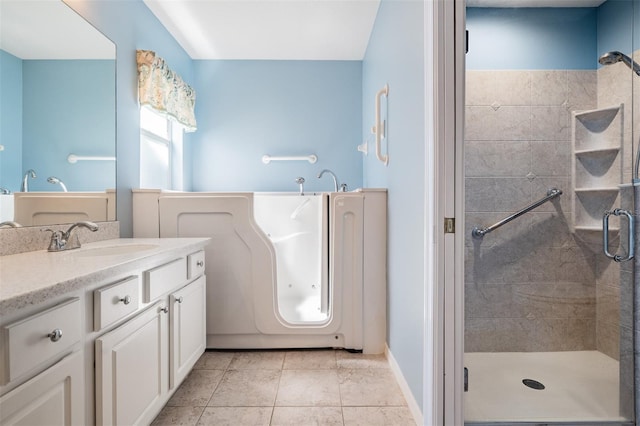 full bath featuring a shower stall, tile patterned flooring, and vanity