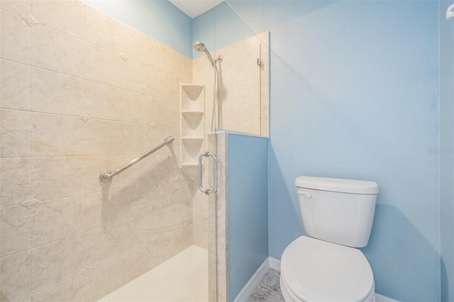 full bath featuring a shower stall, toilet, and baseboards