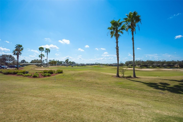 view of home's community with a yard and view of golf course