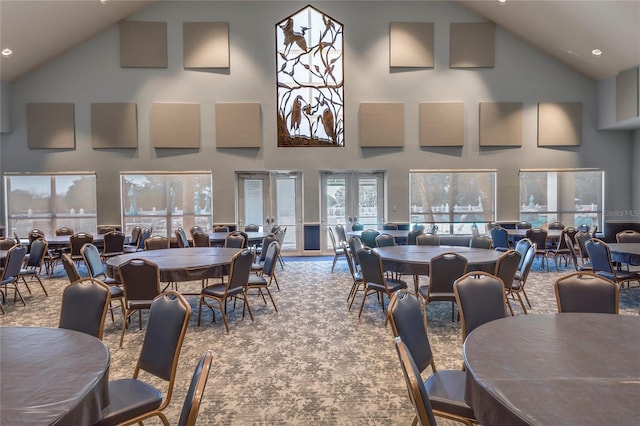 carpeted dining space featuring a high ceiling and french doors