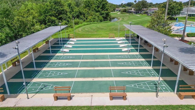 view of community featuring shuffleboard and a lawn