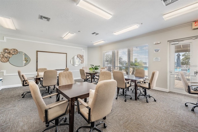 dining space with light carpet, visible vents, and crown molding