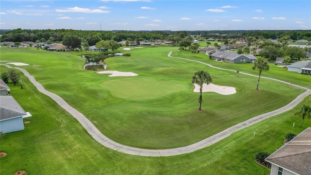 birds eye view of property featuring golf course view, a water view, and a residential view