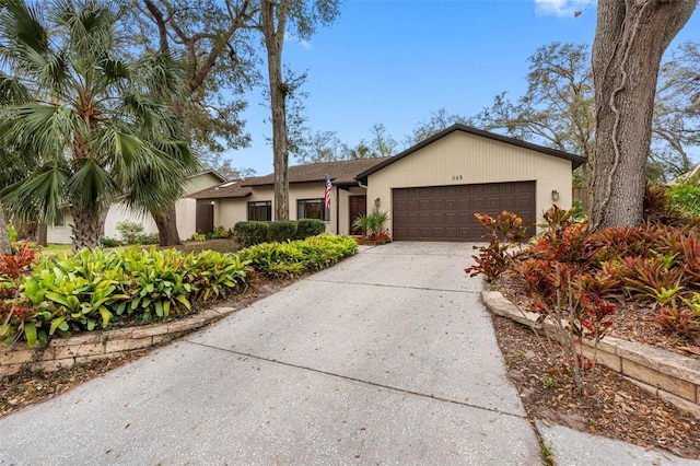 view of front of house with driveway, an attached garage, and stucco siding