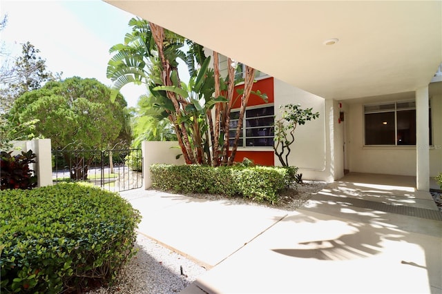 exterior space featuring a gate and stucco siding