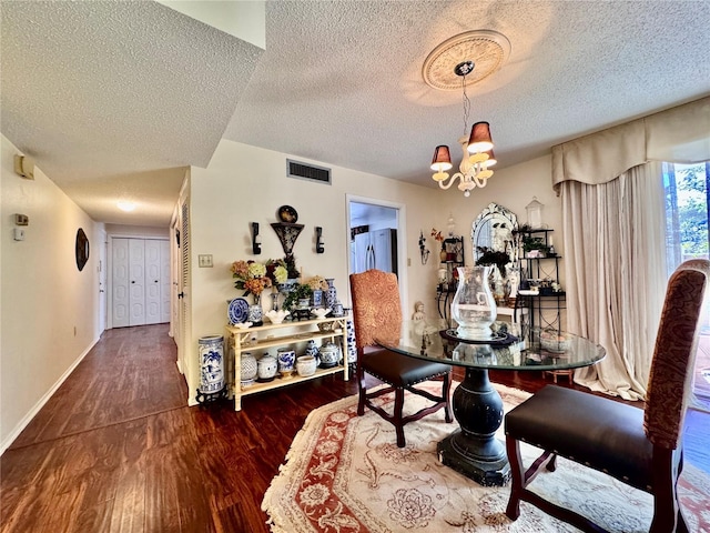 2630 Pearce Dr Unit 107, Clearwater, FL 33764 - dining space with a textured ceiling, visible vents, a chandelier, and wood finished floors