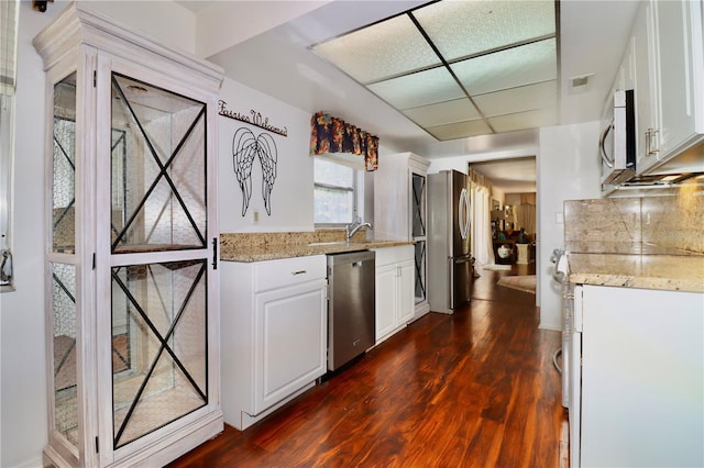 2630 Pearce Dr Unit 107, Clearwater, FL 33764 - kitchen with white cabinets, visible vents, light stone countertops, appliances with stainless steel finishes, and dark wood-type flooring