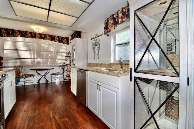 2630 Pearce Dr Unit 107, Clearwater, FL 33764 - kitchen with white cabinets, dishwasher, dark wood finished floors, a sink, and light stone counters