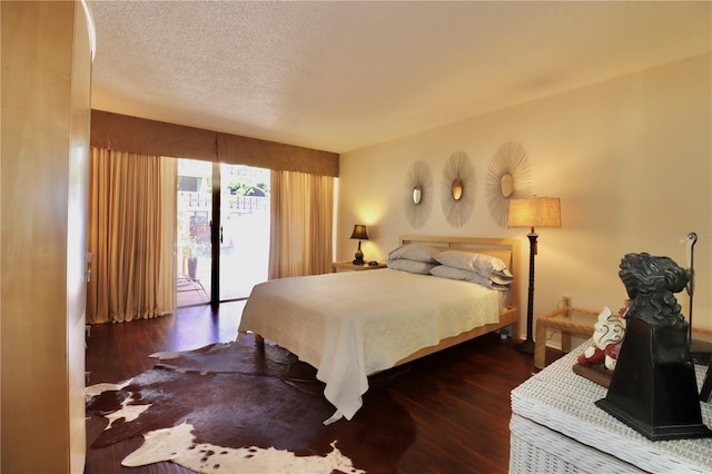 2630 Pearce Dr Unit 107, Clearwater, FL 33764 - bedroom with a textured ceiling, access to exterior, and wood finished floors