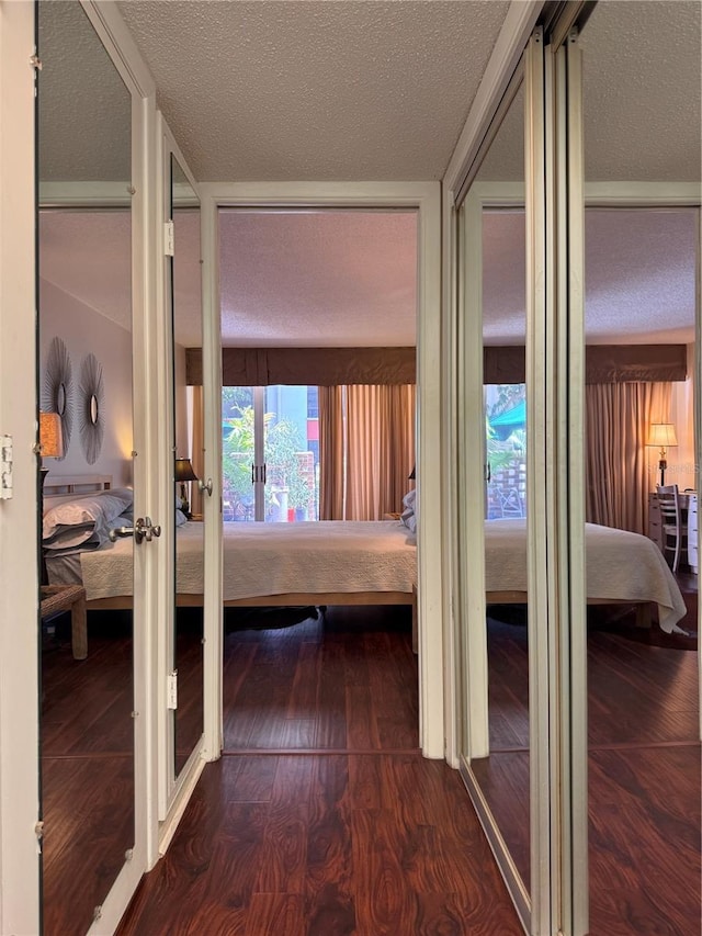 2630 Pearce Dr Unit 107, Clearwater, FL 33764 - corridor featuring dark wood-style floors, french doors, and a textured ceiling