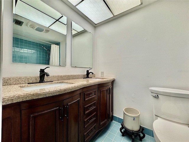 2630 Pearce Dr Unit 107, Clearwater, FL 33764 - full bathroom featuring tile patterned floors, toilet, baseboards, and a sink
