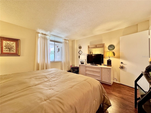 2630 Pearce Dr Unit 107, Clearwater, FL 33764 - bedroom featuring dark wood-type flooring and a textured ceiling