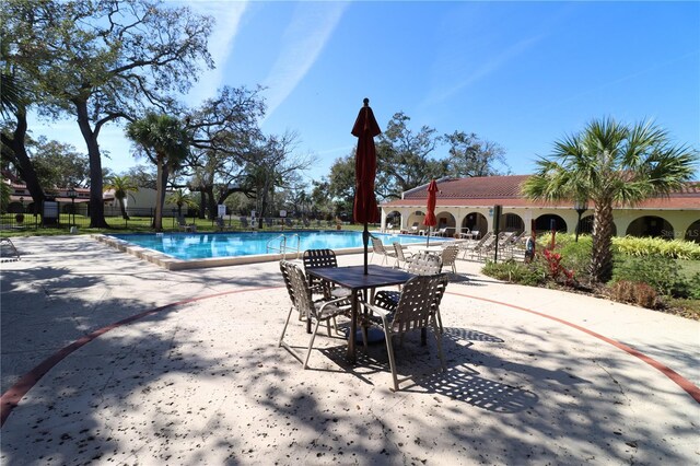 2630 Pearce Dr Unit 107, Clearwater, FL 33764 - community pool featuring fence and a patio