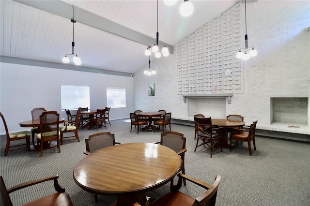 2630 Pearce Dr Unit 107, Clearwater, FL 33764 - dining space with high vaulted ceiling, beamed ceiling, a fireplace, brick wall, and carpet floors