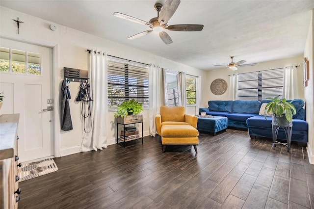 interior space with ceiling fan, dark wood finished floors, and baseboards