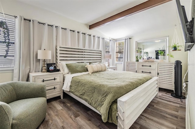 bedroom with dark wood finished floors and vaulted ceiling with beams