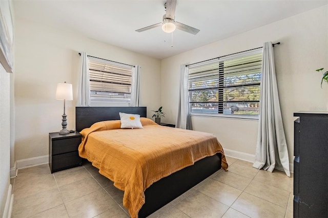 bedroom with light tile patterned floors, ceiling fan, and baseboards