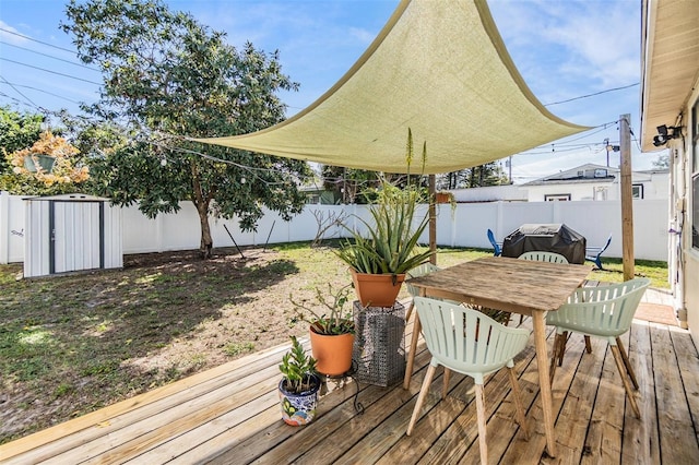 wooden terrace featuring area for grilling and a fenced backyard