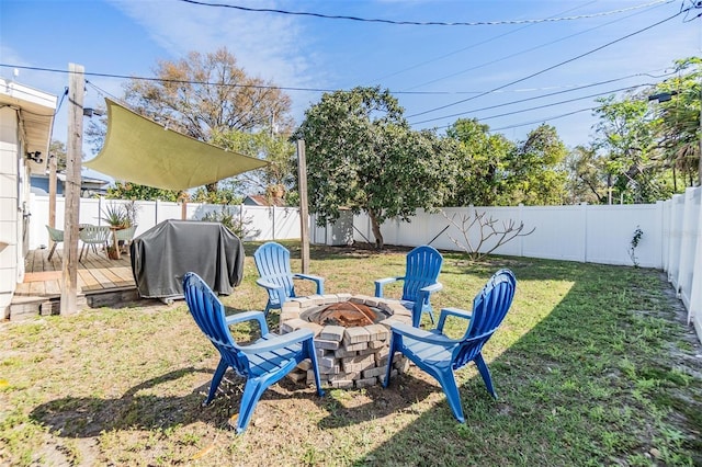 view of yard with an outdoor fire pit, a fenced backyard, and a wooden deck