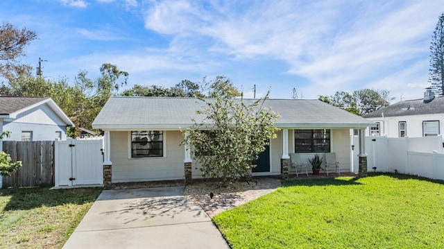 view of front of home featuring a front yard, fence, and a gate