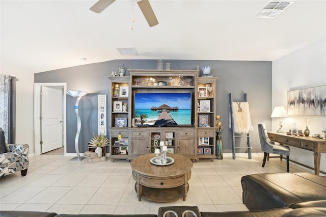 living area with lofted ceiling, visible vents, and light tile patterned floors