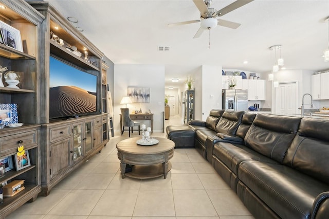 living room with light tile patterned floors, ceiling fan, and visible vents