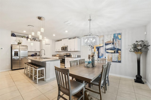 dining room featuring light tile patterned floors, baseboards, a notable chandelier, and recessed lighting