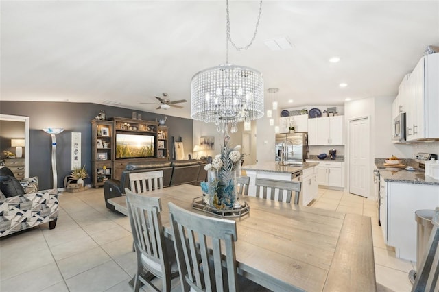 dining space with ceiling fan with notable chandelier, recessed lighting, and light tile patterned floors