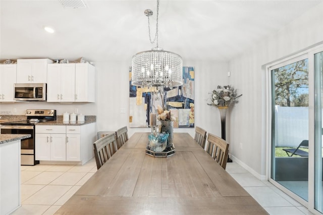 dining area with light tile patterned floors, baseboards, visible vents, and a chandelier