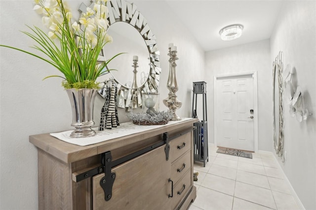 foyer featuring light tile patterned floors and baseboards