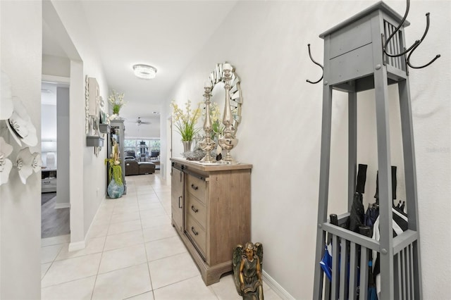 hall with baseboards and light tile patterned floors