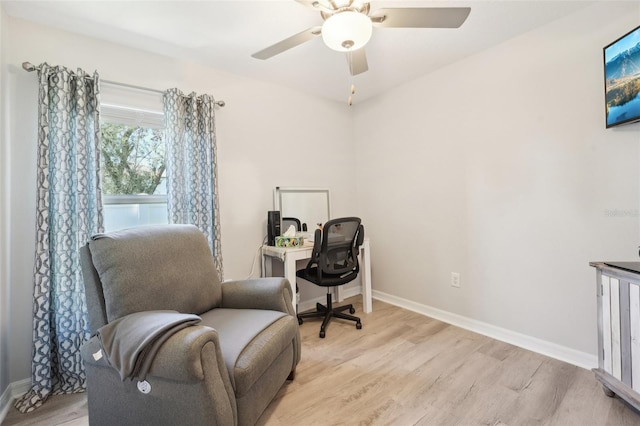 office with light wood-style floors, ceiling fan, and baseboards