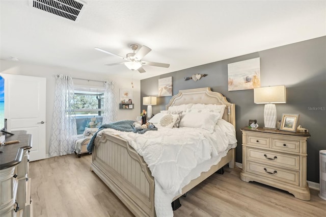 bedroom featuring visible vents, ceiling fan, and light wood-style flooring