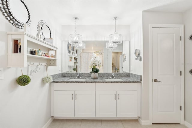 full bathroom with double vanity, a closet, a sink, and tile patterned floors