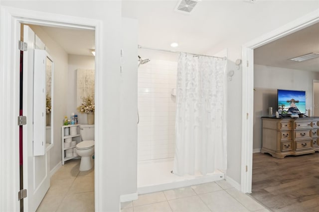 full bathroom featuring tile patterned flooring, visible vents, a shower stall, and toilet