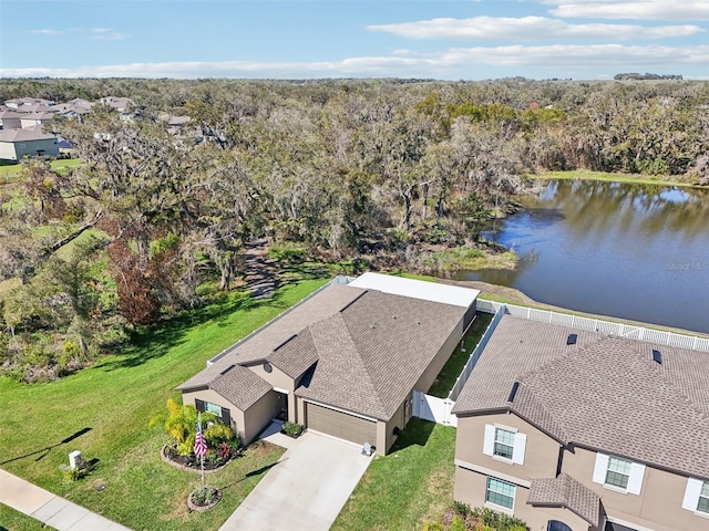 drone / aerial view featuring a water view and a wooded view