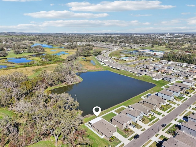 birds eye view of property with a water view and a residential view