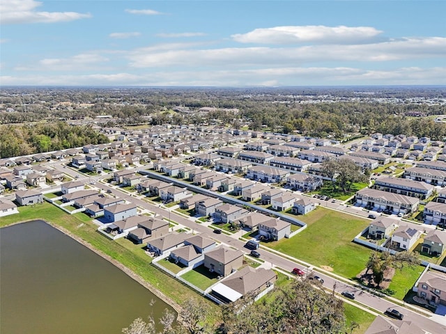 drone / aerial view featuring a water view and a residential view