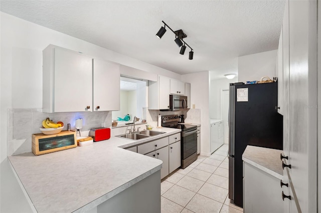 kitchen with light tile patterned floors, decorative backsplash, appliances with stainless steel finishes, light countertops, and a sink